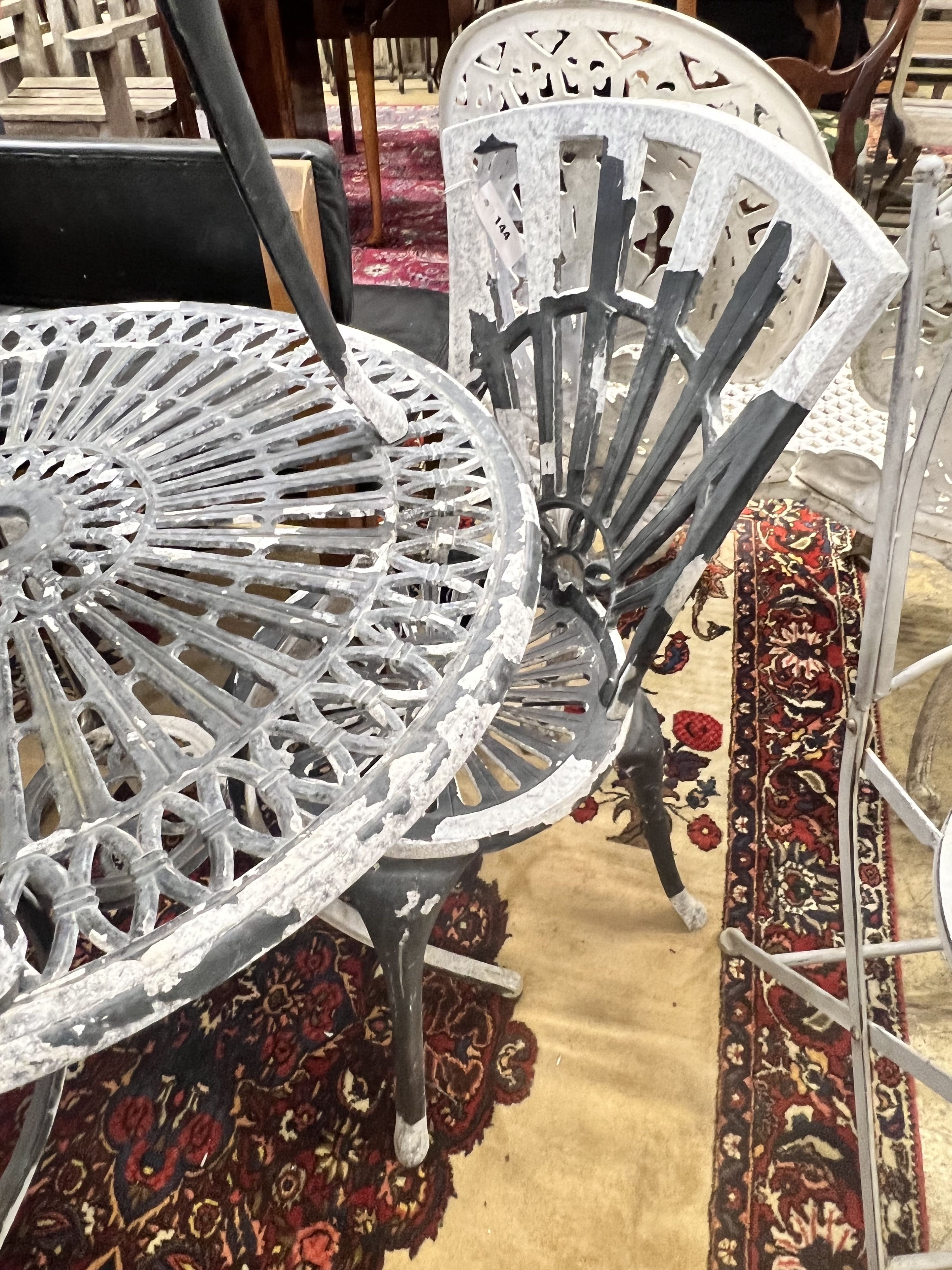A circular aluminium garden table and two chairs, table diameter 69cm height 67cm